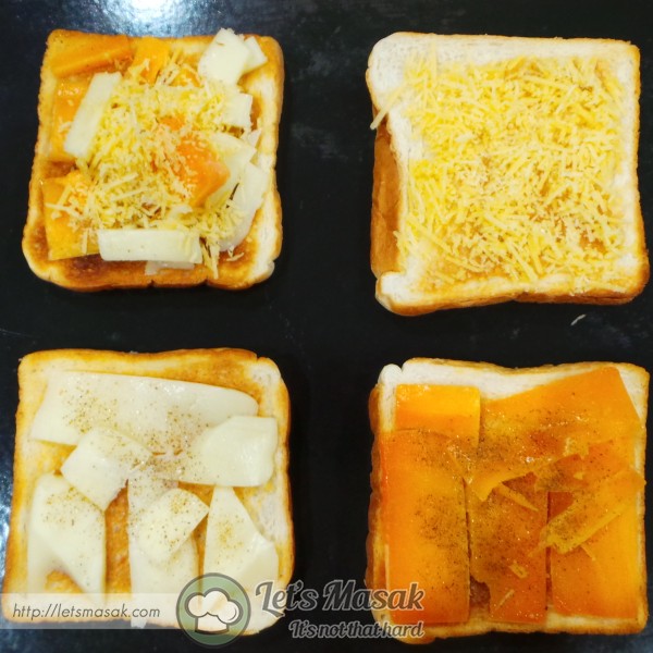 Put the cheeses on the toasts. One of the toast, mix all the cheeses on it. Spread black pepper on each of them.
